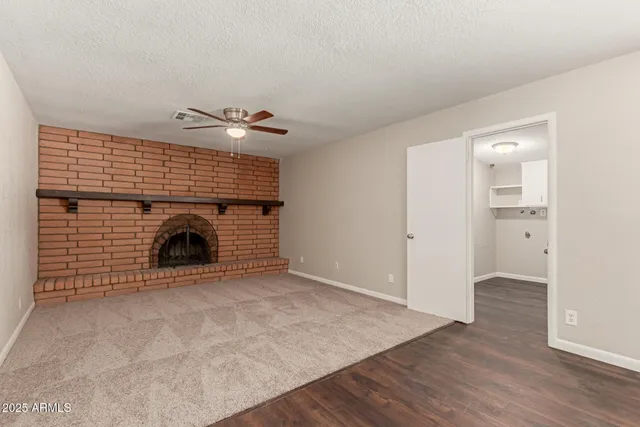 an empty room with closet and a fireplace