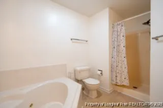 a white toilet sitting next to a bathroom sink and vanity