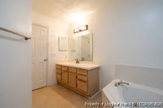 a bathroom with a sink a mirror and a bathtub