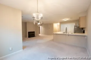 a view of a kitchen with a sink and a chandelier