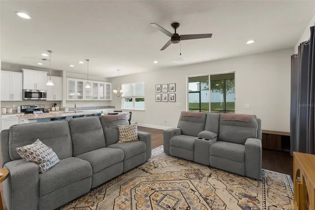 a living room with furniture kitchen view and a dining table
