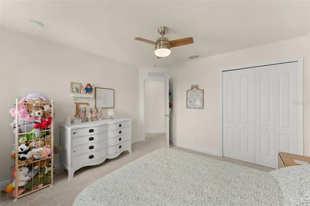 a bedroom with a bed lamp and window