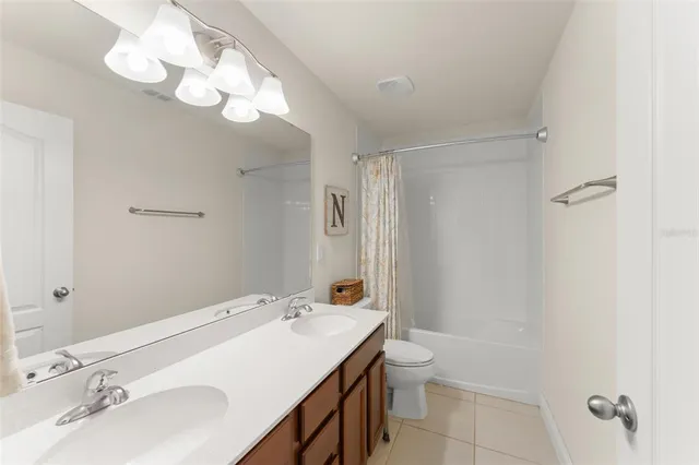 a bedroom with a large bed and a ceiling fan