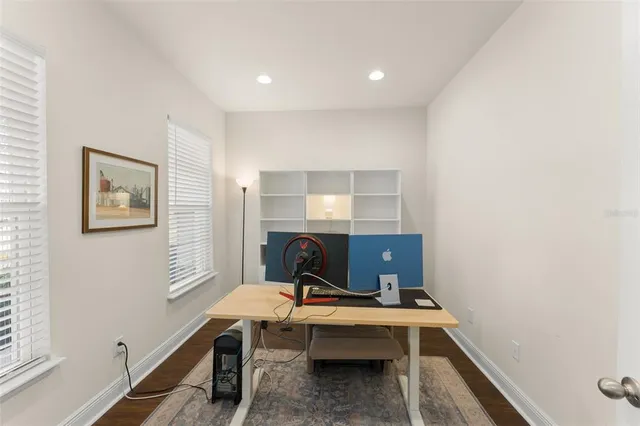 a view of a hallway with furniture and wooden floor