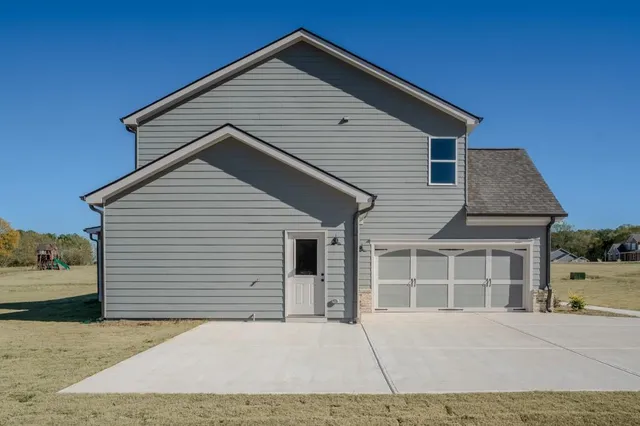 a view of a house with swimming pool and sitting area