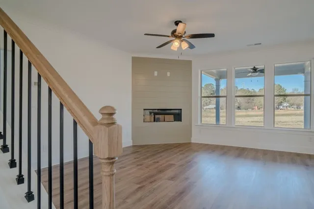 a kitchen that has a lot of cabinets in it and wooden floors