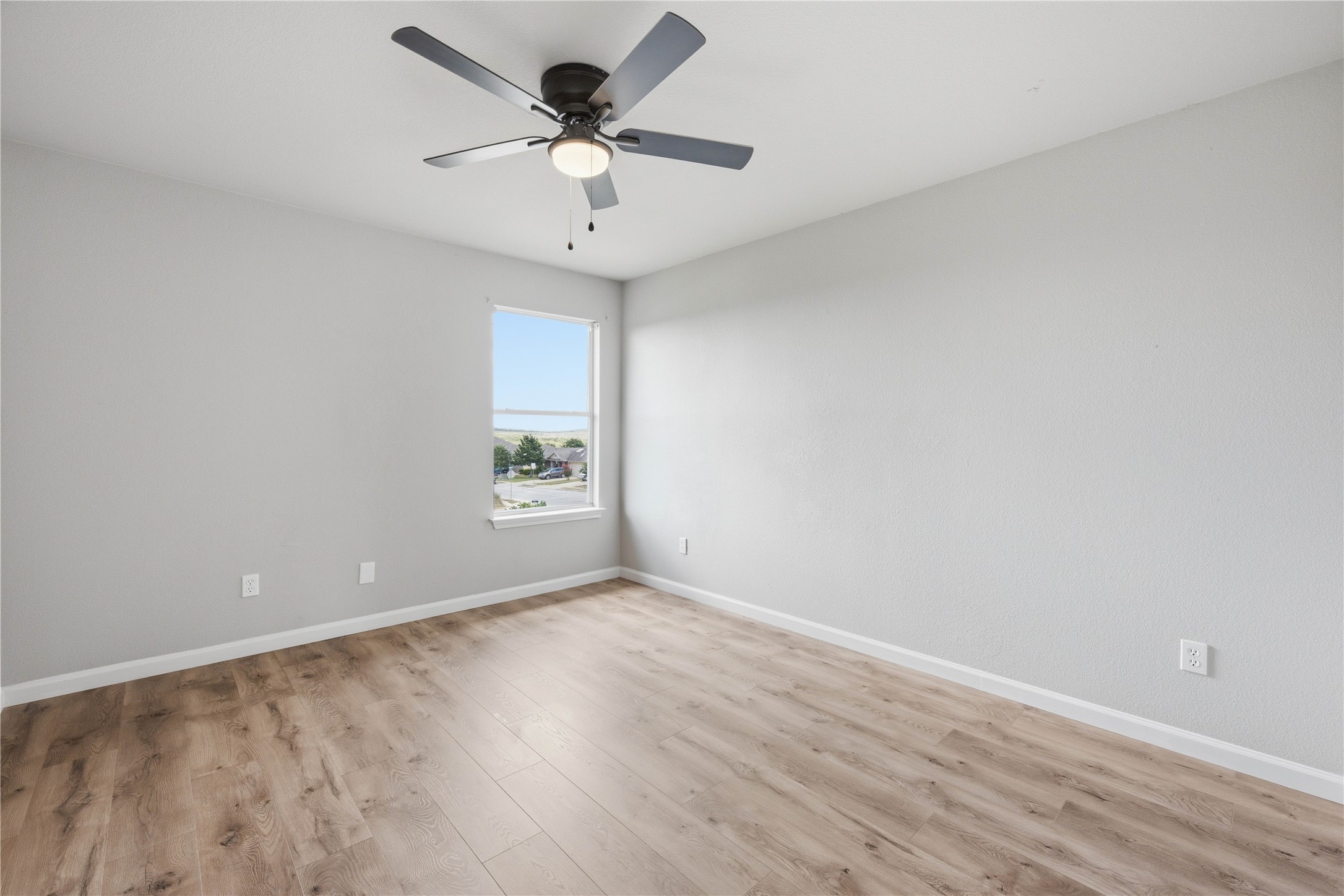 6917 Panda Royle Drive Del Valle, TX 78617 - Photo 17 of 23 Natural light pours into this room, illuminating the durable, low-maintenance wood-look flooring.