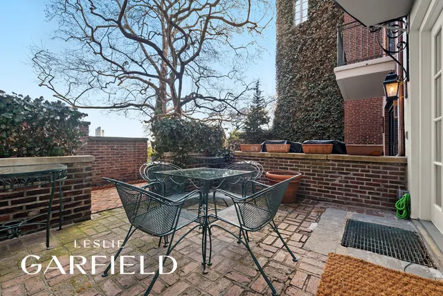 a backyard of a house with table and chairs