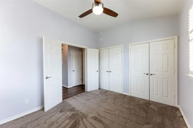 a view of a big room with closet and chandelier fan