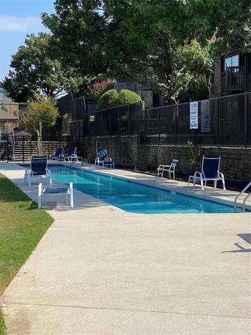 a view of swimming pool with outdoor seating and yard
