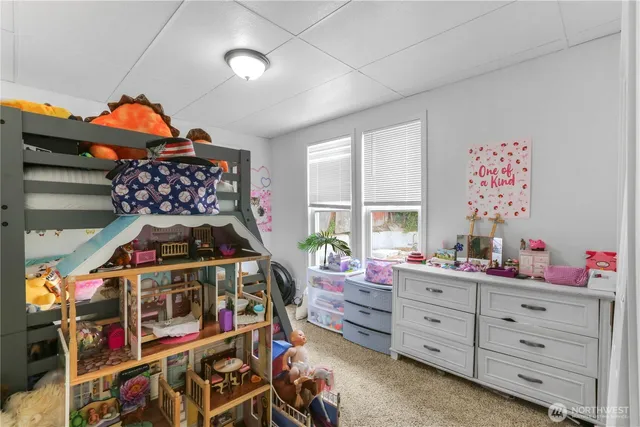 a bedroom with furniture and a baby crib