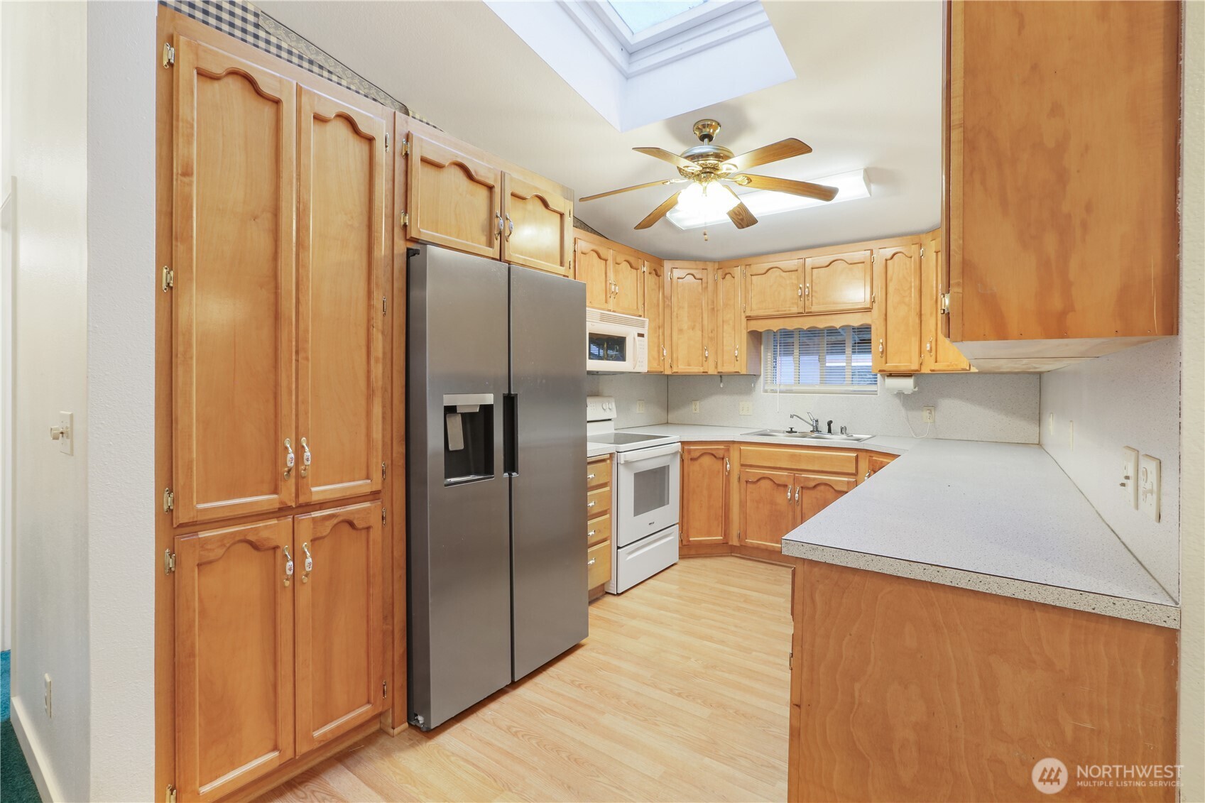 45337 Main Street Concrete, WA 98237 - Photo 27 of 40 a kitchen with stainless steel appliances granite countertop a refrigerator a sink and a stove