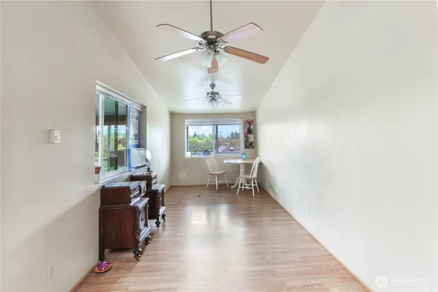 a view of a livingroom with workspace and a window