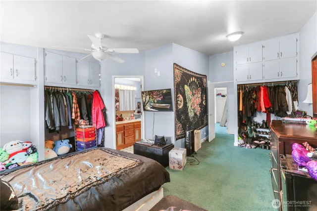 a bed room with a bed a gym equipment and a window