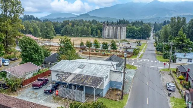 an aerial view of a house with pool lake view and mountain view