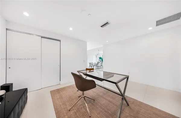 a living room with furniture and large windows