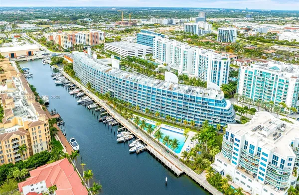 a spacious bedroom with a bed a flat screen tv and next to a window