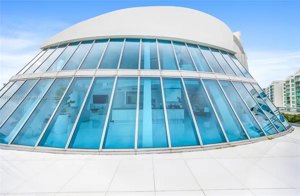 a living room with furniture a flat screen tv and a large window