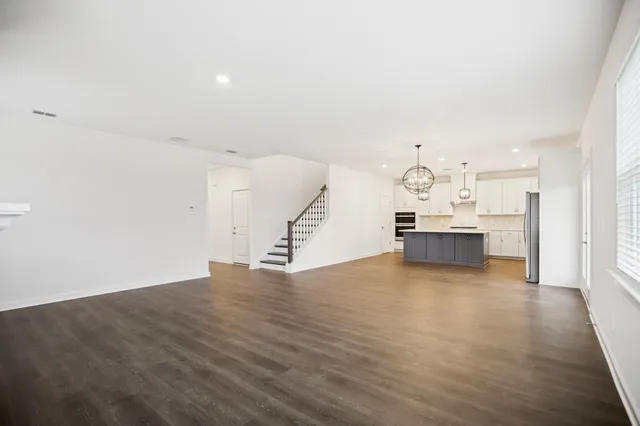 wooden floor fireplace and windows in an empty room