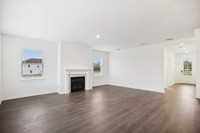 a large kitchen with lot of cabinets and glass door