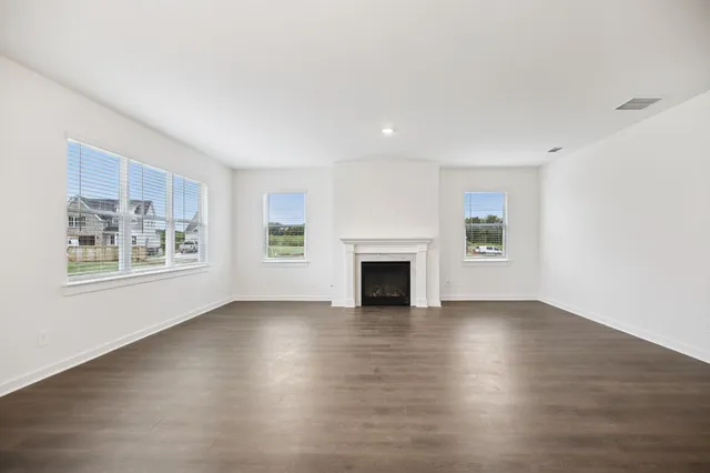 a kitchen with stainless steel appliances a refrigerator and wooden floors