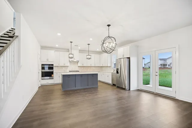 a kitchen with white cabinets and white appliances