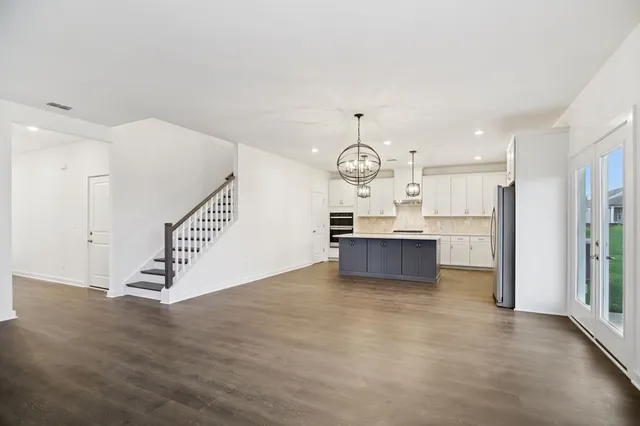 a kitchen with stainless steel appliances a refrigerator sink and cabinets