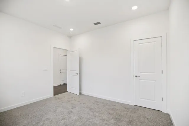 a bathroom with a granite countertop sink a toilet and shower