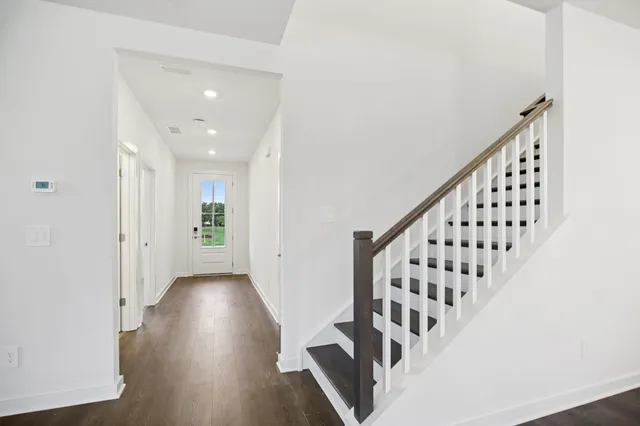a view of an empty room with a window and fireplace