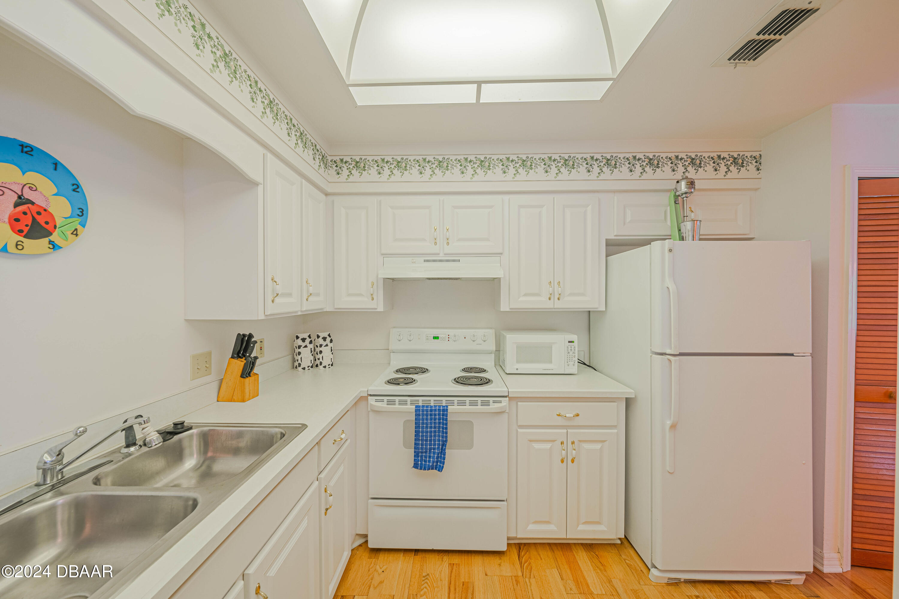 42 Jana Drive Ponce Inlet, FL 32127 - Photo 17 of 34 a kitchen with a sink stove and refrigerator