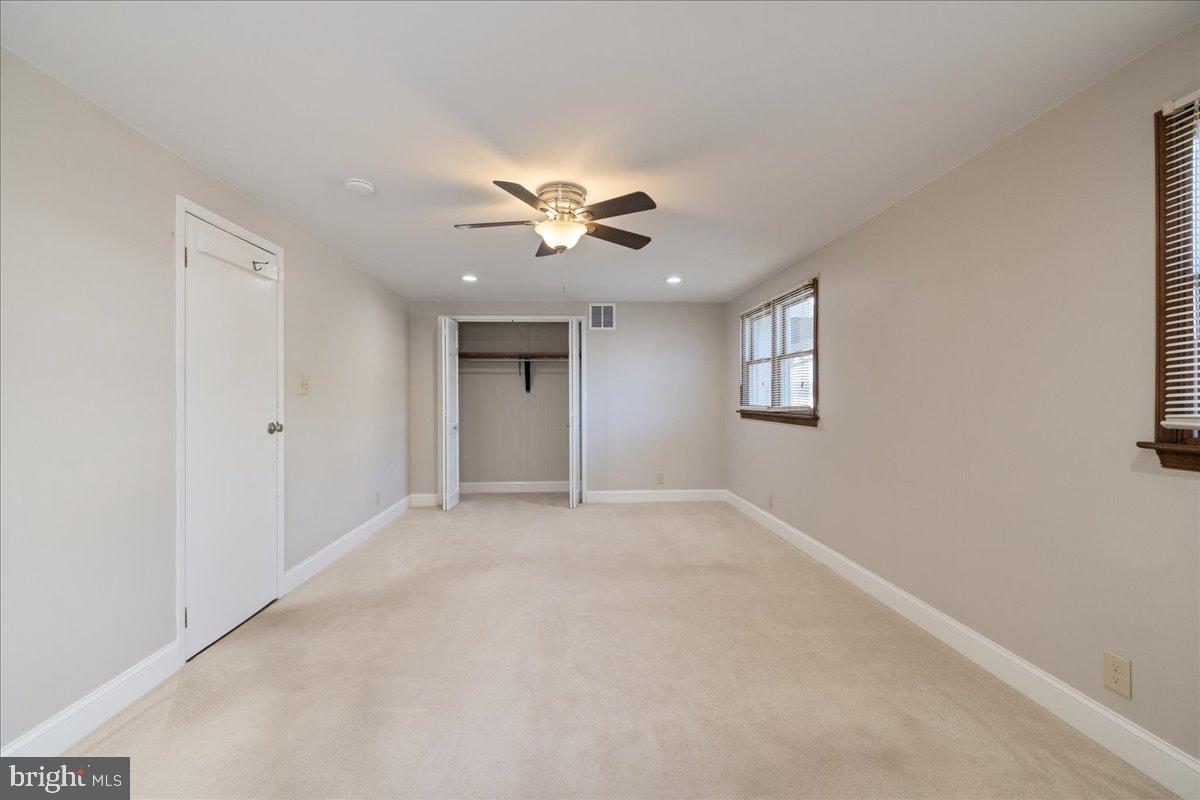 563 Deep Run Road Perkasie, PA 18944 - Photo 13 of 61 an empty room with chandelier fan and windows