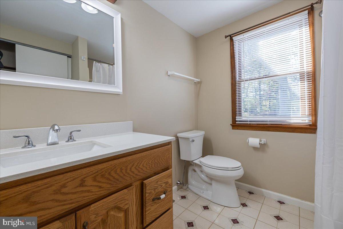 563 Deep Run Road Perkasie, PA 18944 - Photo 18 of 61 a bathroom with a granite countertop sink a toilet and a window