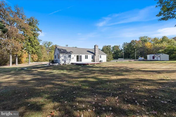 a front view of a house with a garden and yard