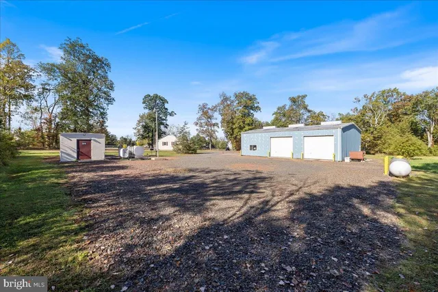 an aerial view of a residential house with a yard
