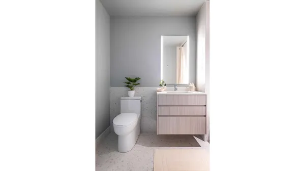 a bathroom with a sink toilet and mirror