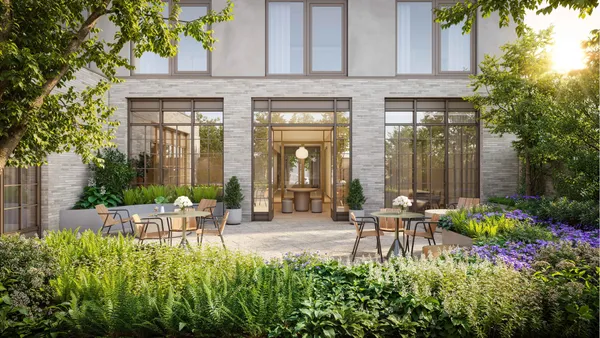 a view of a chair and tables in the patio in front of house