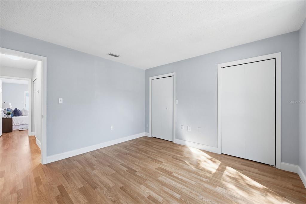 8233 Redfield Drive Port Richey, FL 34668 - Photo 27 of 36 a view of empty room with wooden floor