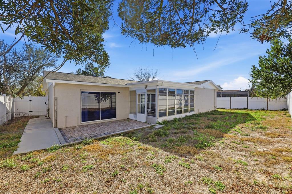 8233 Redfield Drive Port Richey, FL 34668 - Photo 34 of 36 a view of a house with a yard and tree s