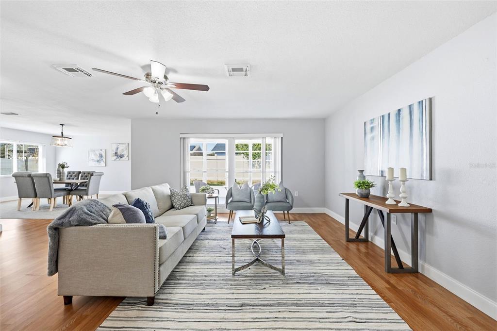 8233 Redfield Drive Port Richey, FL 34668 - Photo 5 of 36 a living room with furniture a table and wooden floor