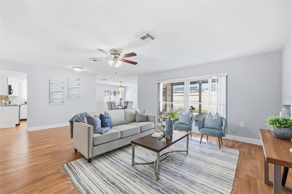 8233 Redfield Drive Port Richey, FL 34668 - Photo 6 of 36 a living room with furniture and wooden floor