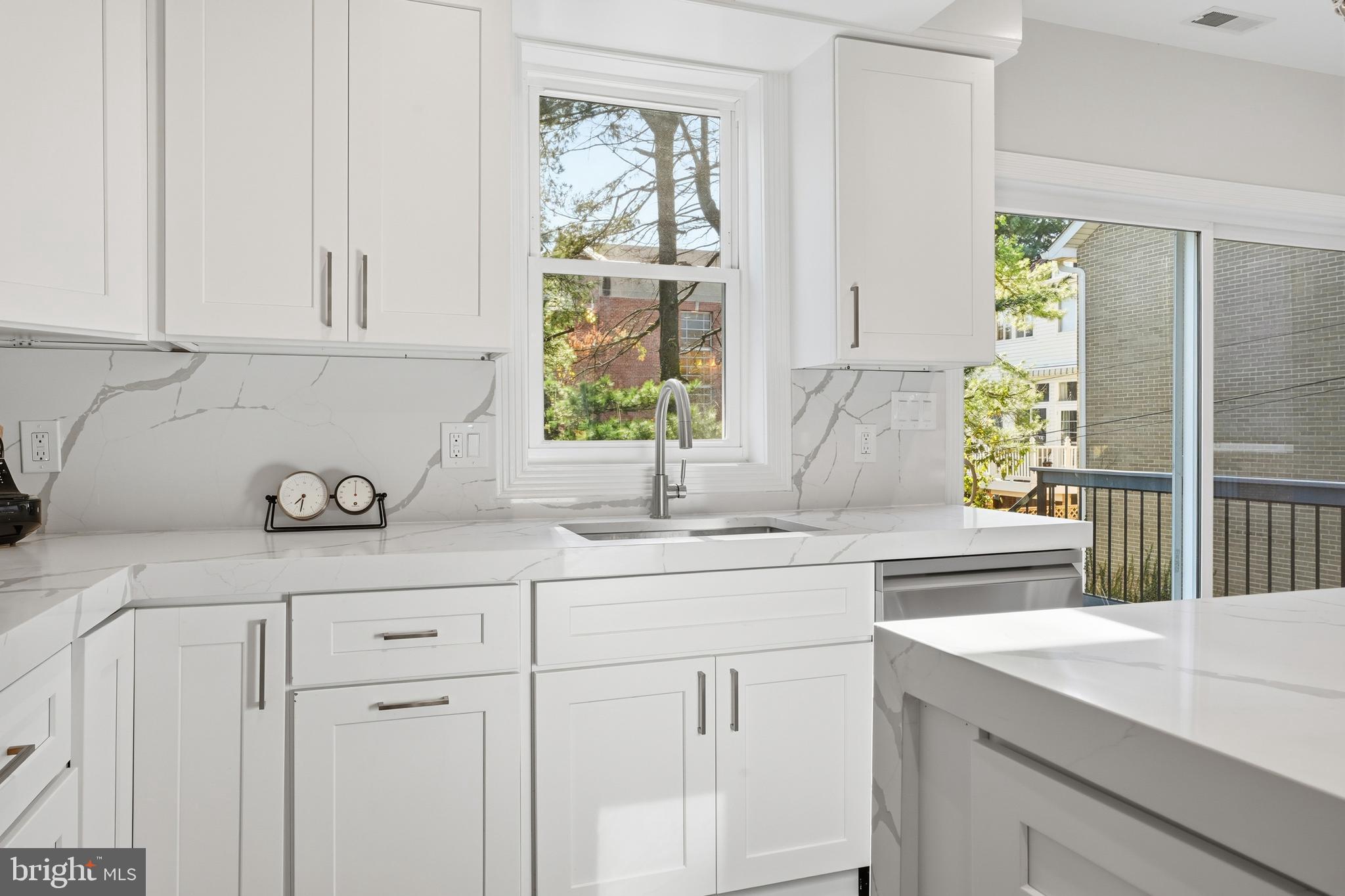 1524 Allison Street Northwest Washington, DC 20011 - Photo 15 of 85 a kitchen with stainless steel appliances white cabinets and a window