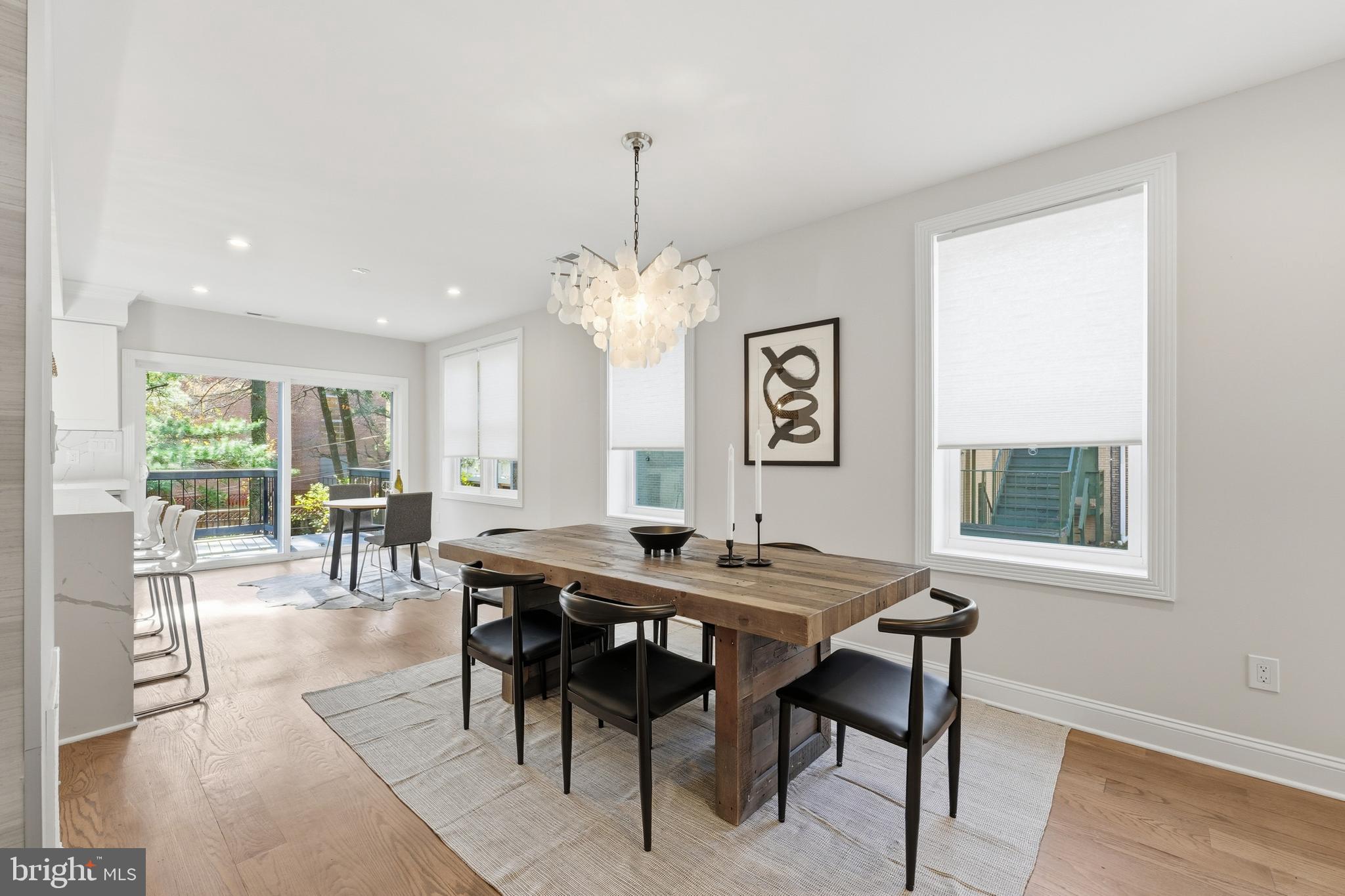 1524 Allison Street Northwest Washington, DC 20011 - Photo 17 of 85 a dining room with wooden floor a chandelier a wooden table and chairs