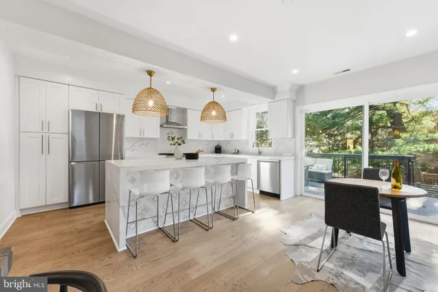 a bathroom with a granite countertop sink mirror next to a window