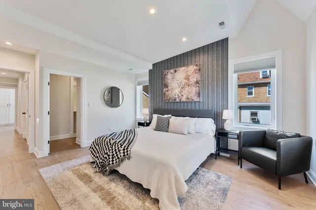 a bedroom with a bed and a window