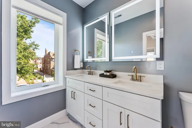 a bathroom with a sink toilet a mirror and shower
