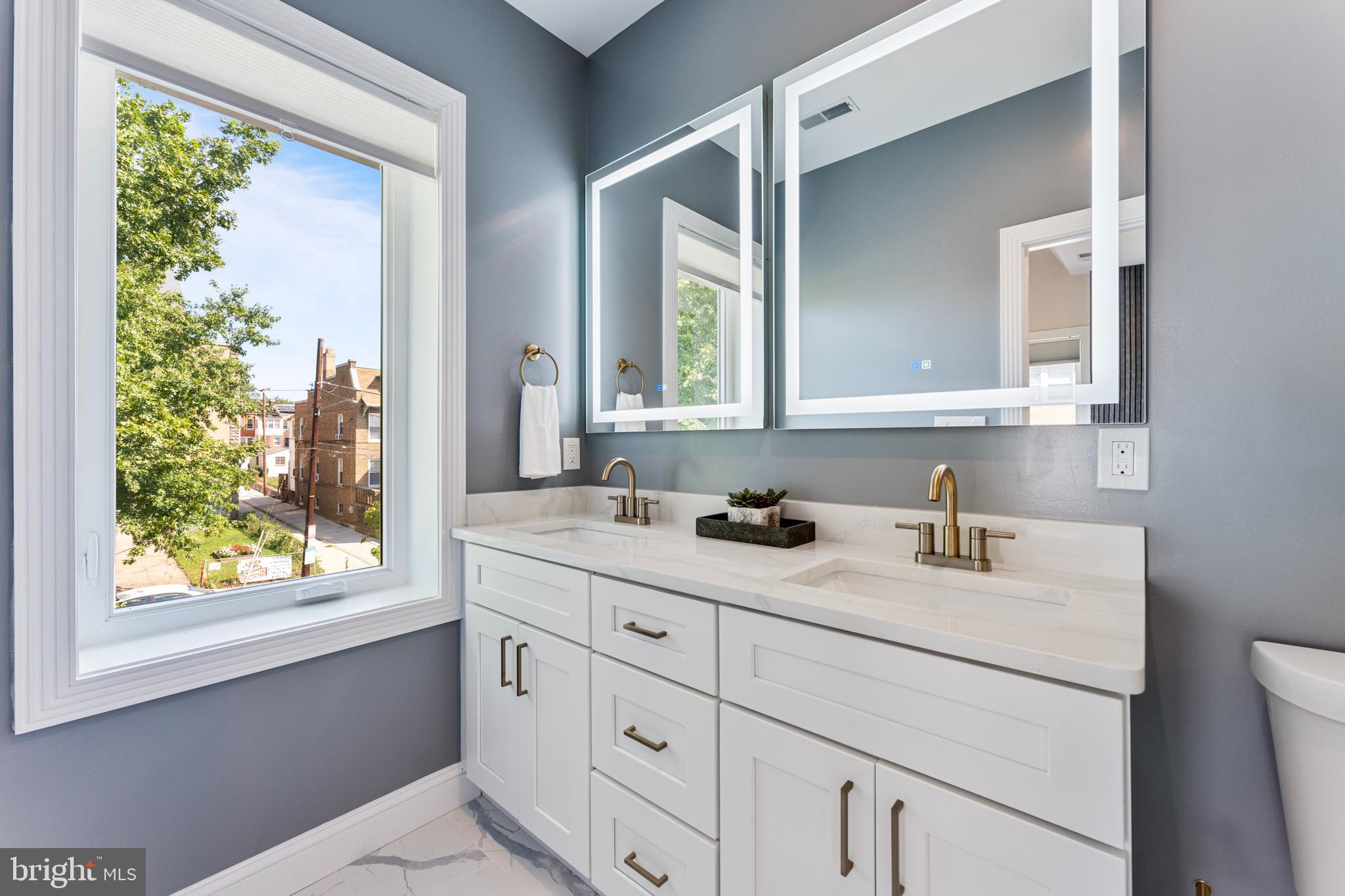 1524 Allison Street Northwest Washington, DC 20011 - Photo 25 of 85 a bathroom with a granite countertop sink mirror next to a window