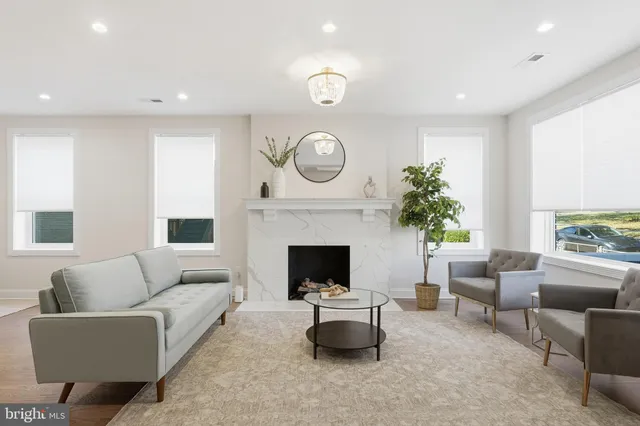 a living room with furniture and a fireplace