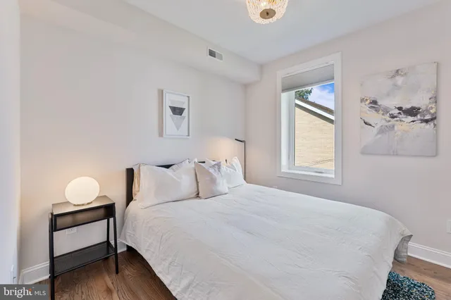a kitchen with stainless steel appliances a dining table chairs and granite counter tops