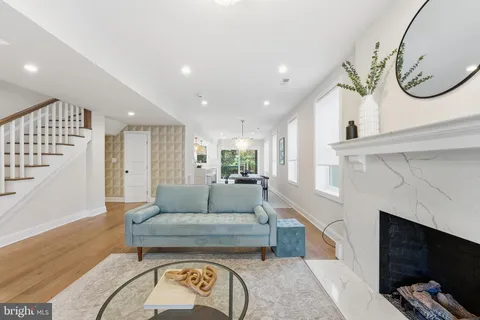 a living room with furniture a fireplace and a flat screen tv