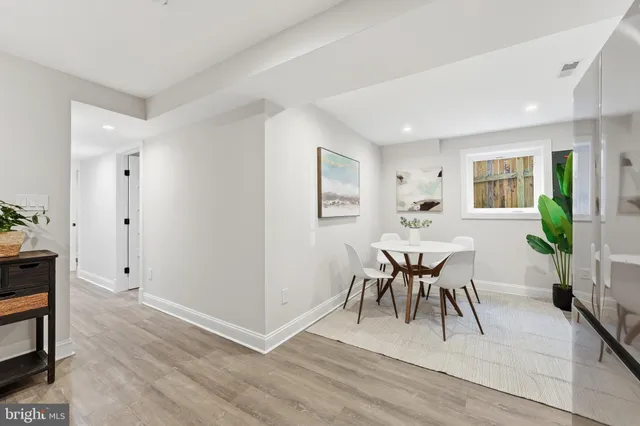 a bedroom with a bed and painting on the wall